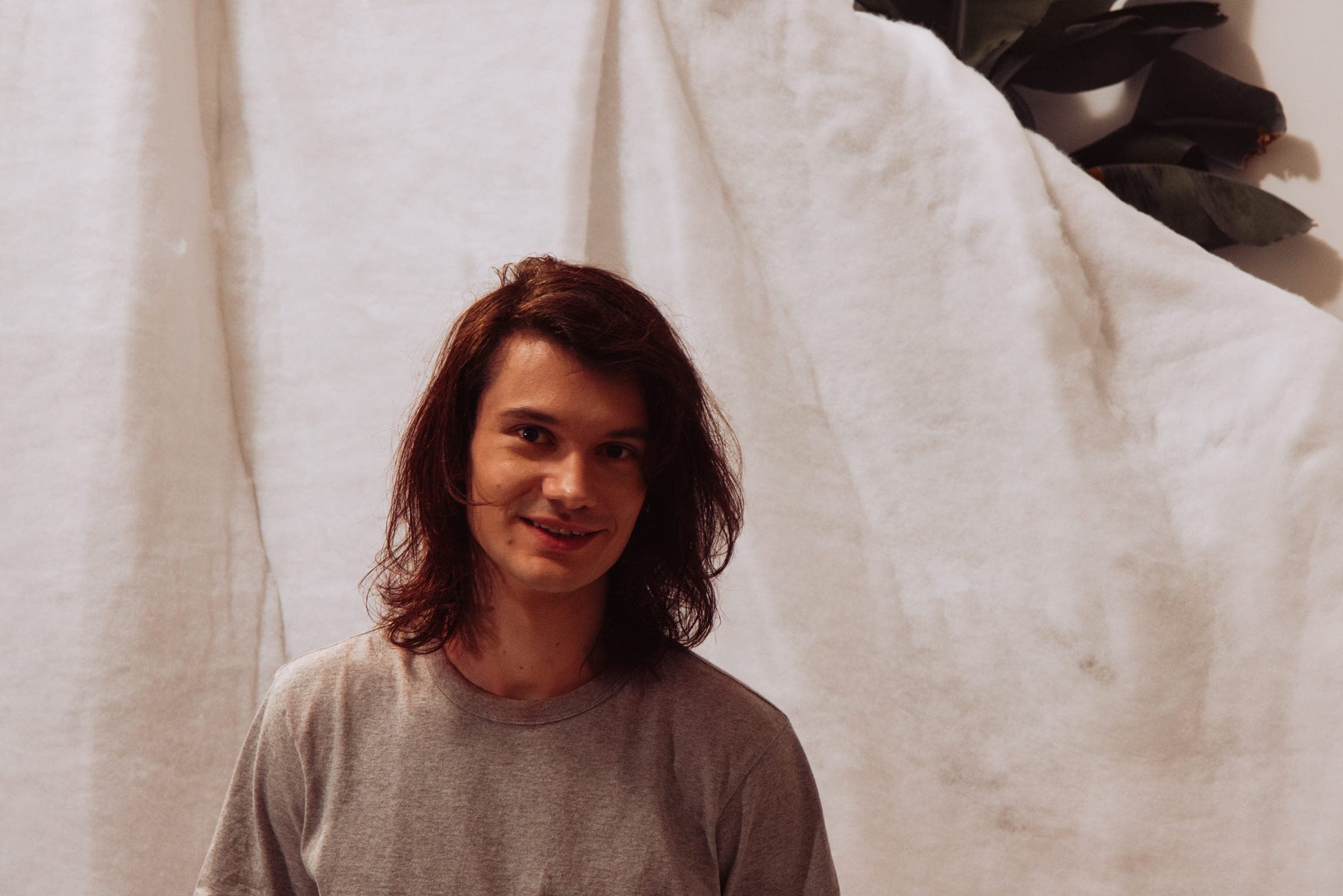 Portrait du comédien souriant devant la toile blanche
